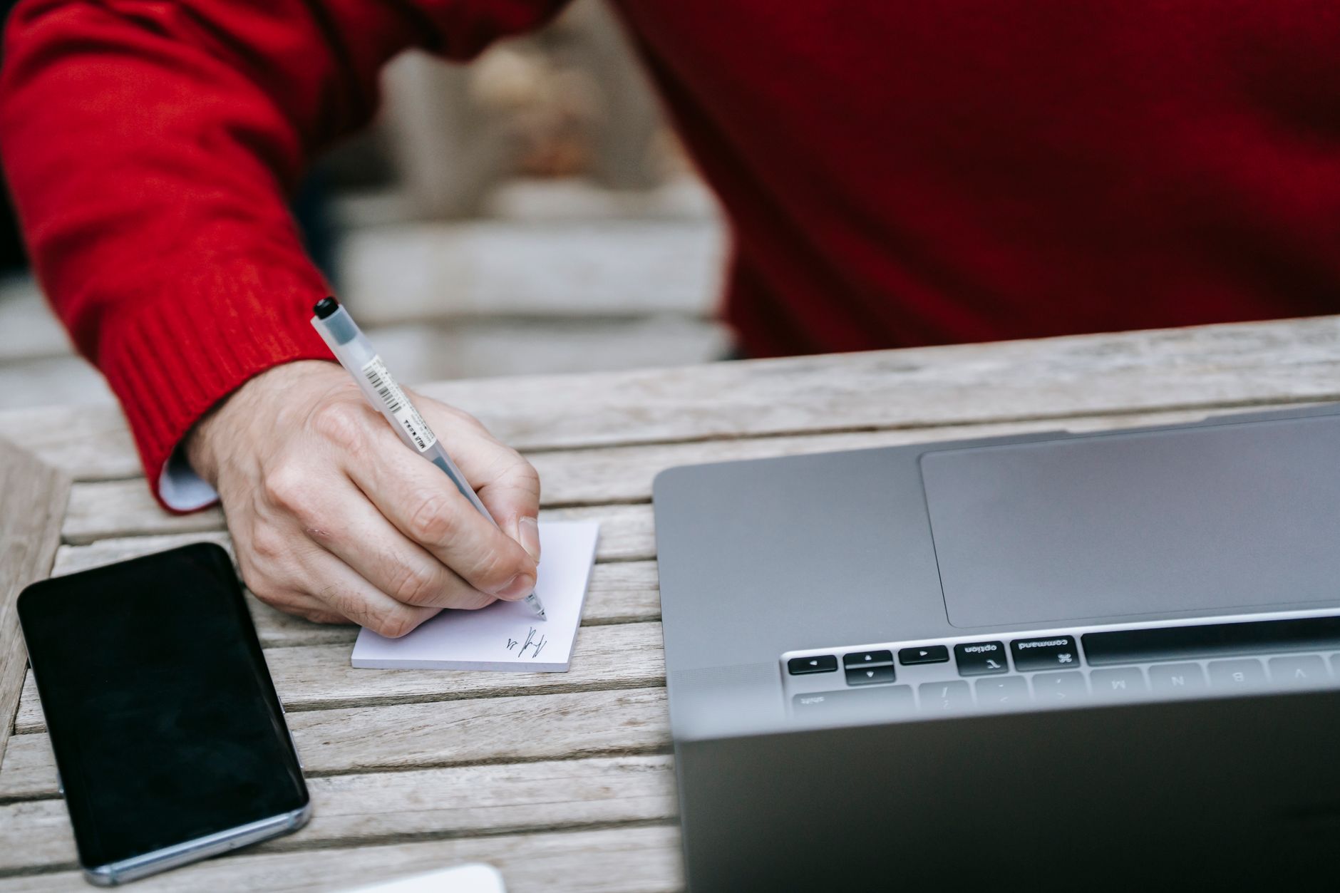 photo of person writing on white paper